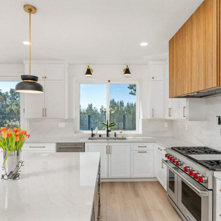 Modern white kitchen with wood Hood and waterfall island in South Orange County