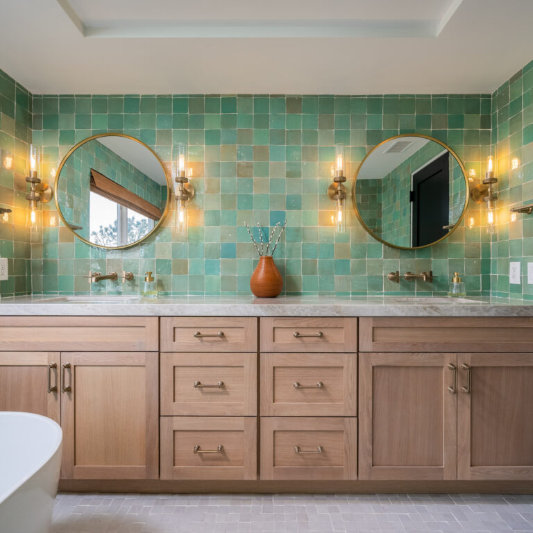 Bathroom with white oak cabinets, green 4x4 tile walls, and Taj Mahal quartzite countertop in Dana Point.