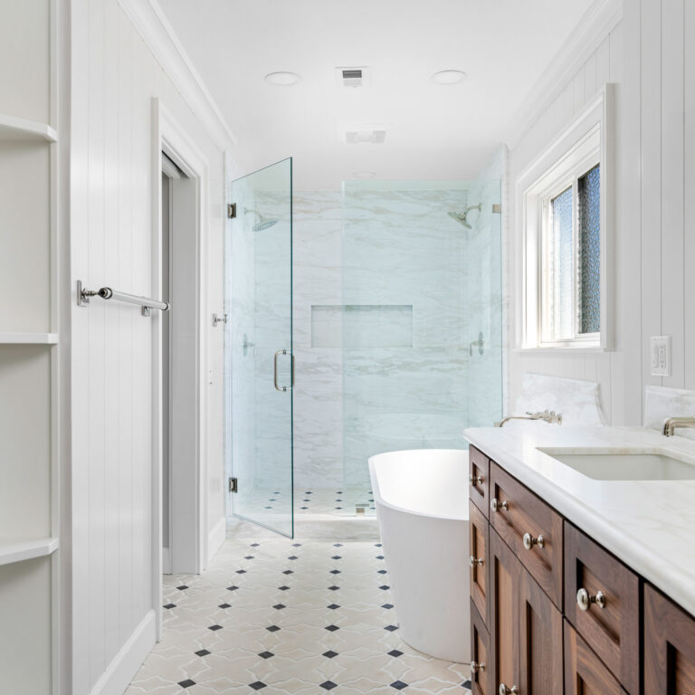 Laguna Niguel bathroom with marble slab shower walls and black-and-white patterned concrete tile flooring.