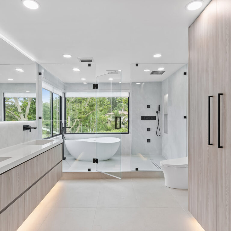 Luxury modern bathroom with freestanding tub, glass shower, and minimalist cabinetry in Newport Beach